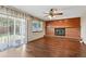 Bright living room with a brick fireplace and access to a patio at 3973 S Joplin Way, Aurora, CO 80013