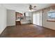 Open-concept living room with hardwood floors leading to kitchen with stainless steel appliances at 3973 S Joplin Way, Aurora, CO 80013
