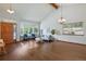 Bright living room with hardwood floors, vaulted ceilings, and a large window, creating an open and airy feel at 3973 S Joplin Way, Aurora, CO 80013