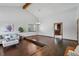 Open living room featuring hardwood floors, vaulted ceilings, and ample natural light from a large window at 3973 S Joplin Way, Aurora, CO 80013