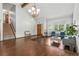 Bright living room features hardwood floors, large windows, and a decorative chandelier at 3973 S Joplin Way, Aurora, CO 80013