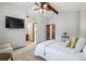 Bright main bedroom with vaulted ceiling, ceiling fan, TV and ensuite bath at 3973 S Joplin Way, Aurora, CO 80013