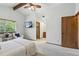 Bright main bedroom with vaulted ceiling, ceiling fan, TV and ensuite bath at 3973 S Joplin Way, Aurora, CO 80013