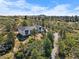 Striking aerial shot of a modern home surrounded by lush greenery and a winding driveway at 922 W Wolfensberger Rd, Castle Rock, CO 80109