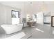 Bright bathroom with a freestanding tub, glass-enclosed shower, and stylish vanity with modern lighting at 922 W Wolfensberger Rd, Castle Rock, CO 80109