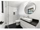 Sleek bathroom with a glass-enclosed shower, modern vanity, and stylish black and white accents at 922 W Wolfensberger Rd, Castle Rock, CO 80109