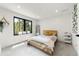 Cozy bedroom with large window, modern decor, and soft natural light at 922 W Wolfensberger Rd, Castle Rock, CO 80109