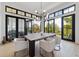 Bright dining room with modern chandelier and views through large windows at 922 W Wolfensberger Rd, Castle Rock, CO 80109
