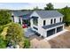 Modern farmhouse with black framed windows, dark metal awnings, a three-car garage and backyard at 922 W Wolfensberger Rd, Castle Rock, CO 80109
