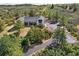 Beautiful home with dark roof trim surrounded by green trees, accessed by a paved driveway at 922 W Wolfensberger Rd, Castle Rock, CO 80109