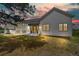 Charming single-Gathering home with manicured lawn, modern white facade, and front entrance with black awning at 922 W Wolfensberger Rd, Castle Rock, CO 80109