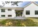 The front entrance features a modern white facade and black framed door with sidelights and potted plants at 922 W Wolfensberger Rd, Castle Rock, CO 80109