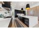 Spacious kitchen featuring an island with wine fridge, contrasting cabinetry, and stainless steel appliances at 922 W Wolfensberger Rd, Castle Rock, CO 80109