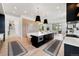 Modern kitchen with large island, hardwood floors, stainless steel appliances and an open floor plan at 922 W Wolfensberger Rd, Castle Rock, CO 80109