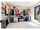 Well-organized walk-in closet with ample shelving, hanging space, and a window for natural light at 922 W Wolfensberger Rd, Castle Rock, CO 80109