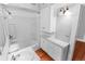 Clean bathroom with a bathtub, sink, and storage cabinets at 1317 S University Blvd, Denver, CO 80210