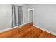 Well-lit bedroom showcasing hardwood floors and a closet at 1317 S University Blvd, Denver, CO 80210