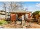 Brick home with a covered porch and a yard at 1317 S University Blvd, Denver, CO 80210