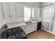 Kitchen with white cabinets, black appliances, and linoleum floor at 1317 S University Blvd, Denver, CO 80210