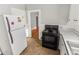 Small kitchen with white cabinets and black appliances at 1317 S University Blvd, Denver, CO 80210