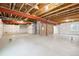 Unfinished basement area featuring an insulated wall and open ceiling with exposed wood beams and ductwork at 1321 Loraine N Cir, Lafayette, CO 80026
