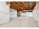 Spacious unfinished basement ready for customization, featuring open ceiling beams and insulated exterior walls at 1321 Loraine N Cir, Lafayette, CO 80026