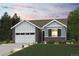 Charming, single-story home features a brick and siding exterior and well-manicured landscaping at 1321 Loraine N Cir, Lafayette, CO 80026