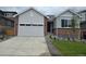 Charming single-Gathering home with a spacious driveway, landscaped front yard, and attached two-car garage at 1321 Loraine N Cir, Lafayette, CO 80026