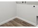 A room with light wood floors, a light wall with electric outlets, and white trim around the base of the wall at 1321 Loraine N Cir, Lafayette, CO 80026