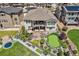 Aerial view of large backyard with putting green, fire pit and trampoline at 21786 Tyrolite Ave, Parker, CO 80138