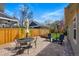 Charming backyard with a paver patio, comfortable seating, and a manicured lawn, perfect for outdoor gatherings at 9826 E 27Th Dr, Denver, CO 80238