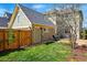 Green backyard featuring a well-maintained lawn, mature landscaping, and an outdoor dining area at 9826 E 27Th Dr, Denver, CO 80238