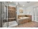 A bathroom featuring a shower, soaking tub, and tiled walls at 9826 E 27Th Dr, Denver, CO 80238