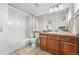 Bathroom showcasing a vanity, a shower-tub combination, and neutral tile flooring at 9826 E 27Th Dr, Denver, CO 80238