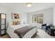 Comfortable bedroom featuring a queen-sized bed, stylish furniture, and a large window for natural light at 9826 E 27Th Dr, Denver, CO 80238