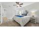 Cozy bedroom featuring a queen-sized bed, neutral decor, and a large window for natural light at 9826 E 27Th Dr, Denver, CO 80238