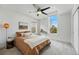 Bright bedroom with a ceiling fan, modern windows, and cozy decor creating a relaxing atmosphere at 9826 E 27Th Dr, Denver, CO 80238