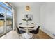 Bright dining area with modern table, stylish chairs, and sliding glass doors leading to outdoor space at 9826 E 27Th Dr, Denver, CO 80238