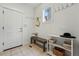 An entryway featuring a bench, shelving, hooks and a white front door at 9826 E 27Th Dr, Denver, CO 80238