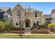 Charming two-story home featuring well-maintained landscaping and a welcoming entrance with a brick retaining wall at 9826 E 27Th Dr, Denver, CO 80238
