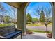 Inviting front porch with a comfortable bench, offering a peaceful view of the neighborhood and a nearby playground at 9826 E 27Th Dr, Denver, CO 80238