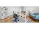 Comfortable home office featuring hardwood floors, an ergonomic chair, and plenty of natural light, perfect for productivity at 9826 E 27Th Dr, Denver, CO 80238