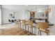 Kitchen island with bar stool seating, stainless steel appliances, and modern lighting fixtures at 9826 E 27Th Dr, Denver, CO 80238