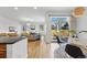 Open living and dining area with hardwood floors and natural light, transitioning to the outdoor patio at 9826 E 27Th Dr, Denver, CO 80238