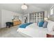 Bright bedroom with a white bed, blue accents, and custom built-in storage at 9826 E 27Th Dr, Denver, CO 80238