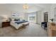 Spacious main bedroom with soft carpet, large windows, a decorative ceiling light, and a serene atmosphere at 9826 E 27Th Dr, Denver, CO 80238