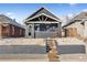 Charming two-story home with a covered front porch, manicured lawn, and classic architectural details at 4045 Navajo St, Denver, CO 80211