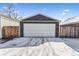 Detached garage with a white door and snow covered driveway at 4045 Navajo St, Denver, CO 80211