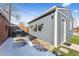 View of a detached garage with a side door, wood siding, and a small yard at 4045 Navajo St, Denver, CO 80211