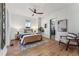 Bright main bedroom with a ceiling fan, hardwood floors, and ensuite bathroom at 4045 Navajo St, Denver, CO 80211